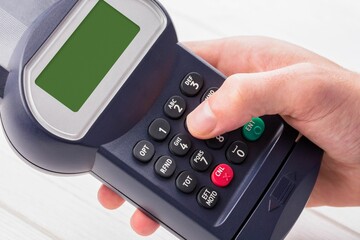 Obraz premium Cropped hand holding credit card reader