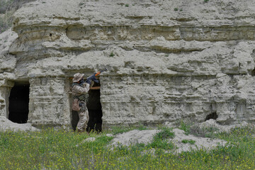 Army soldier performing military maneuvers on the battlefield.