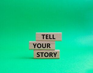 Tell your story symbol. Wooden blocks with words Tell your story. Beautiful green background. Business and Tell your story concept. Copy space.