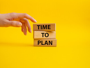 Time to plan symbol. Wooden blocks with words Time to plan. Beautiful yellow background. Businessman hand. Business and Time to plan concept. Copy space.