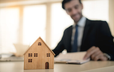 Hand Business calculating interest, taxes and profits to invest in real estate and home buying