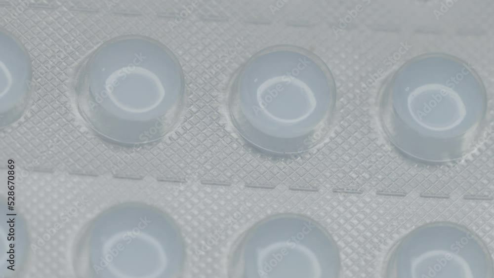 Poster white pills in a blister are rotated in a circle