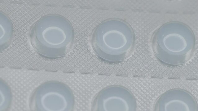 white pills in a blister are rotated in a circle