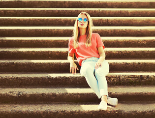 Summer portrait of stylish blonde young woman wearing sunglasses in the city