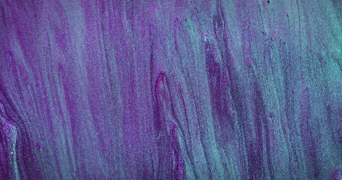 Glitter fluid flow. Shimmering texture. Fantasy waterfall. Fluorescent blue purple color particles holographic abstract background for intro. Shot on RED Cinema camera.