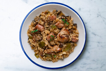 Rice paella with rabbit, sausages and green beans. Tapa traditional recipe in Valencia, Spain.