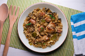 Rice paella with rabbit, sausages and green beans. Tapa traditional recipe in Valencia, Spain.