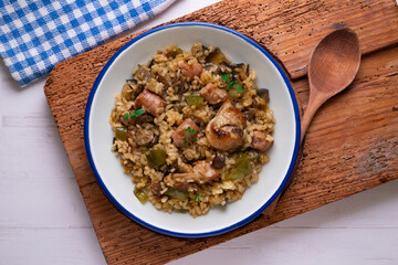Rice paella with rabbit, sausages and green beans. Tapa traditional recipe in Valencia, Spain.