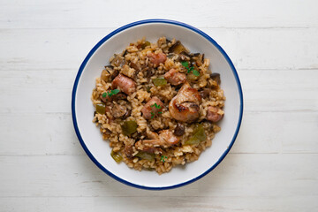 Rice paella with rabbit, sausages and green beans. Tapa traditional recipe in Valencia, Spain.