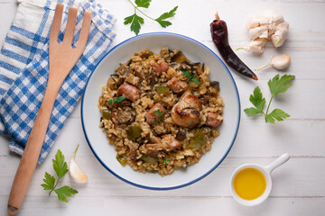 Rice paella with rabbit, sausages and green beans. Tapa traditional recipe in Valencia, Spain.