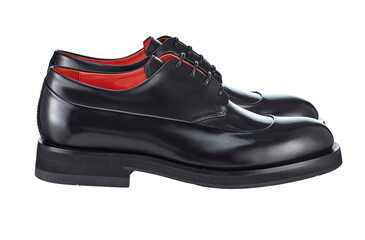 Gorgeous pair of men's derby shoes made of glossy black leather, lace-up, standing on top of each other, with beautiful highlights on the surface, isolated on a white background. Side view.