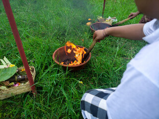 Burning the remaining bones in the Ngaben or cremation ceremony in Bali, Indonesia. It is performed...