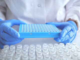 Laboratory scientist working at lab with micro pipette, test tubes and 96 well plate . Laboratory...