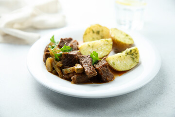 Homemade beef ragout with pickles and potato