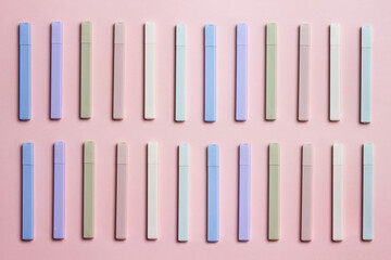 Colorful pens over the pink background. 