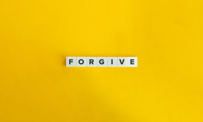 Forgive Word on Block Letter Tiles on Yellow Background. Minimal Aesthetics.