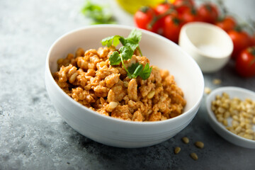 Homemade chicken ragout with pine nuts