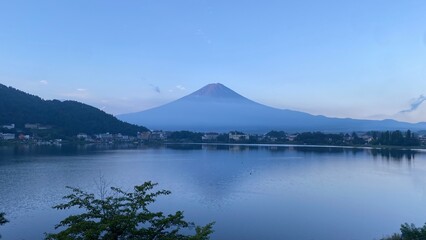 Magnificent Japanese traditional view, Mt Fuji at just after 5:30 am, the beautiful silhouette revealed in whole after cloudy evening the day before.  Photo taken year 2022 August 27th