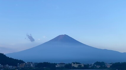 Fototapeta premium Magnificent Japanese traditional view, Mt Fuji at just after 5:30 am, the beautiful silhouette revealed in whole after cloudy evening the day before. Photo taken year 2022 August 27th