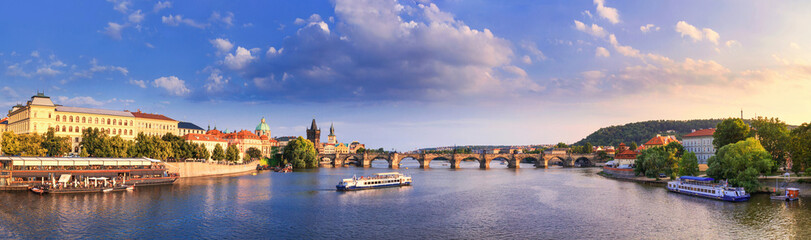 Fototapeta na wymiar City summer landscape at sunset, banner - view of the Charles Bridge and the Vltava river in the historical center of Prague, Czech Republic