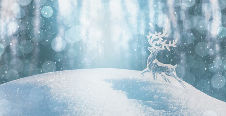 Christmas winter background, banner - view of an ice deer on a snowdrift in a winter forest,...