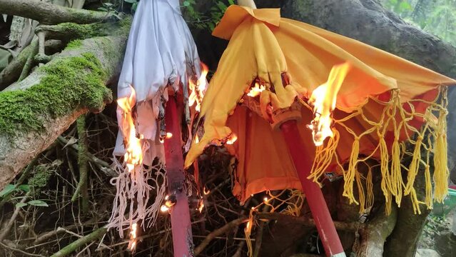 Burning of Balinese umbrella "Tedung" at Ngaben or cremation ceremony in Bali