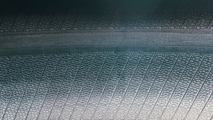 car tires inside black rubber texture. New Tire