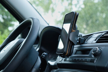 Plastic car phone holder with smartphone in a car