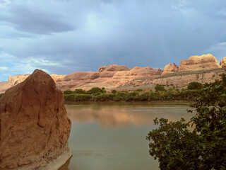 Red rock cliffs reflecting in river