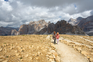 Obraz premium Cute kids are walking in mountain area. Traveling in Italian Dolomites with kids.