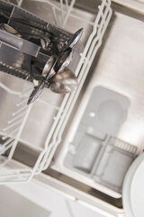 Open container, compartment of a dishwashing machine close up. Dishwasher tablet in a plastic dishwashing container, close-up.