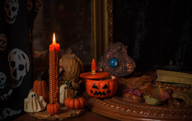 Halloween composition pumpkin orange candles, mystical design for home, interesting ideas for party, details of décor