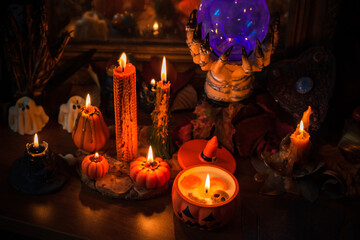 Halloween composition pumpkin orange candles, mystical design for home, interesting ideas for party, details of décor