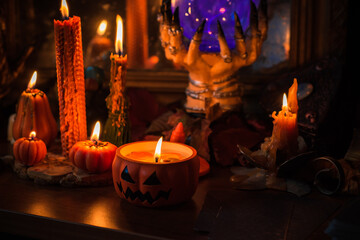 Halloween composition pumpkin orange candles, mystical design for home, interesting ideas for party, details of décor