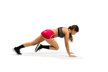Active young woman exercising with cross training and doing mountain climbers
