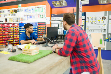 Young man at the cashier while shopping at the hardware store
