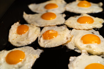 Fried eggs on a baking sheet in a cafe for breakfast