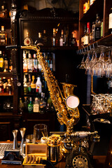 Saxophone on the bar in a pub at night in front of a mirror