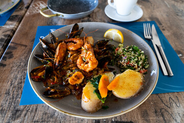 Grilled seafood with a side dish in a cafe
