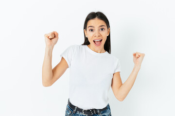 Joyful amazed young woman celebrating
