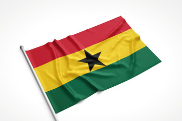 Ghana Flag is Laying on a White Surface