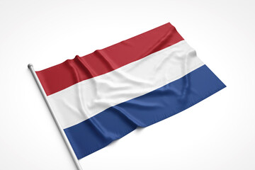 Netherlands Flag is Laying on a White Surface