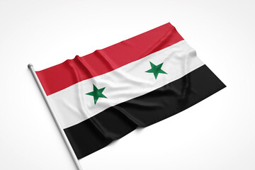Naklejka premium Syrian Flag is Laying on a White Surface