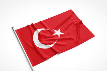 Turkish Flag is Laying on a White Surface