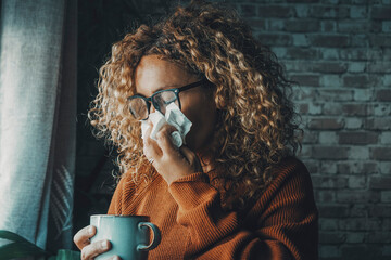 One woman sneezing nose with fever and influenza virus health disease. Flu and cold for winter...
