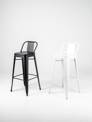 White and black bar chairs on white background