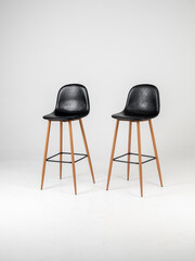 Black bar skin chairs with wood chair leg  and black table on white background