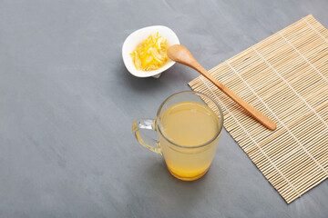 Yuzu tea or yuja tea. Korean citrus tea with high of vitamin C for support immune system. Honey lemon drink. Grey background, copy space