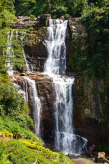 Grandiose unusually beautiful waterfall in the green jungle of the island of Sri Lanka