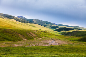 Mountain river in the valley of the Assy plateau. Nomads live in yurts